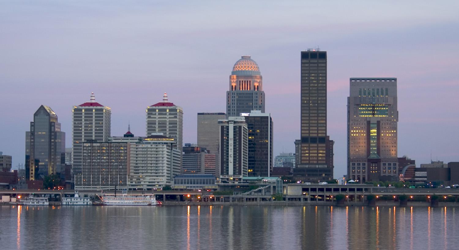 Downtown Louisville skyline at dusk over the Ohio River