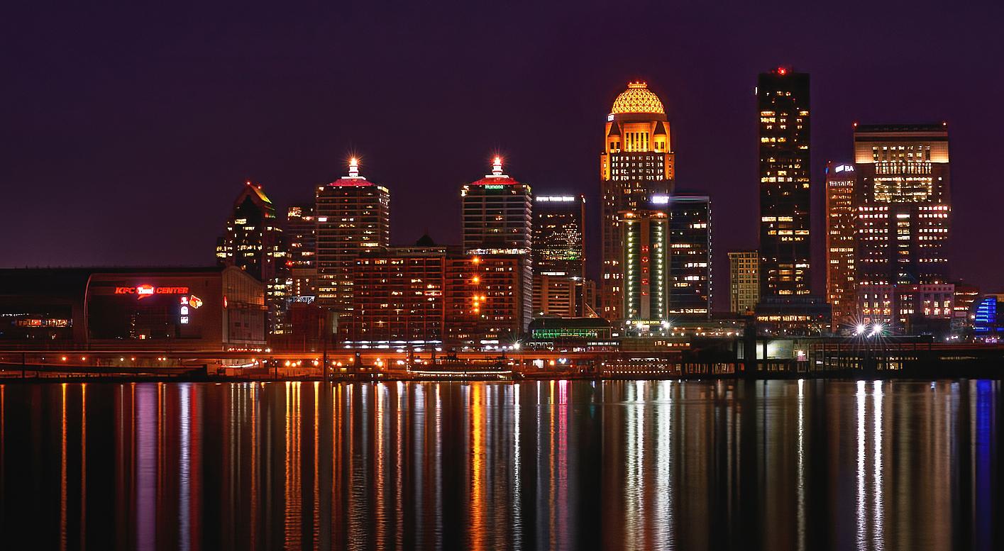 Downtown Louisville skyline at night, reflected in the Ohio River